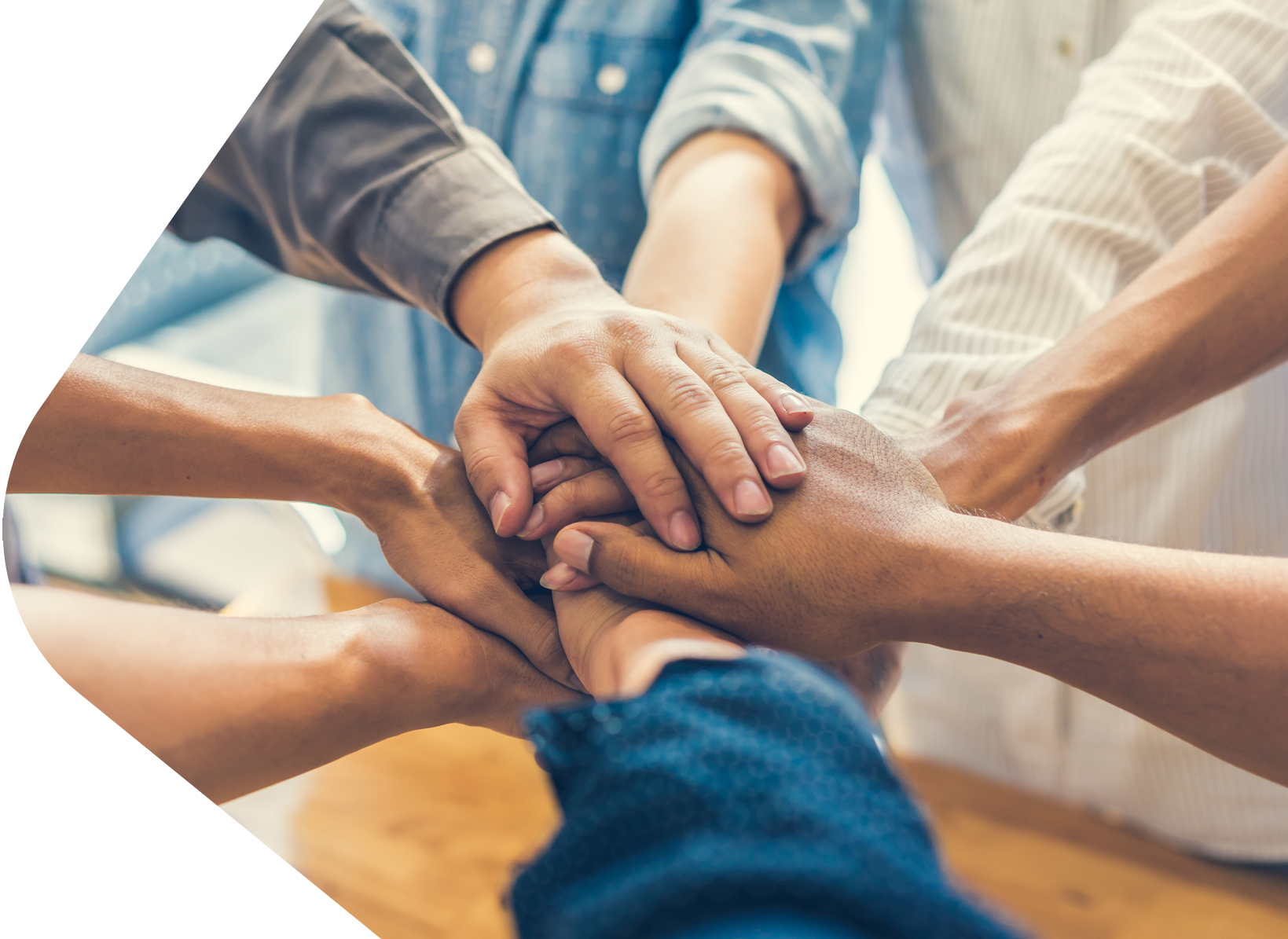 Multi racial hands together in unity forming a close bond